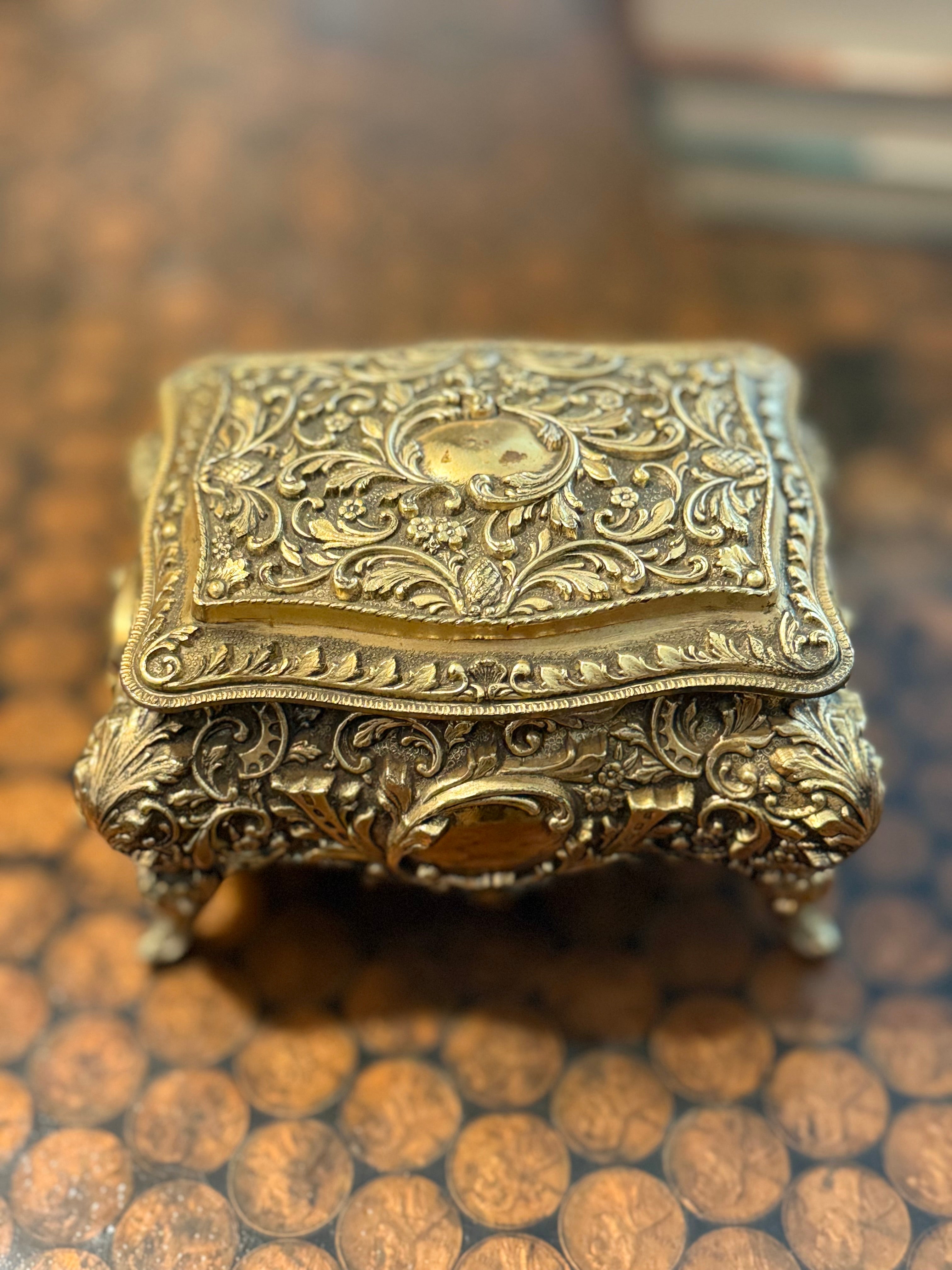 Gold jewelry box with feet